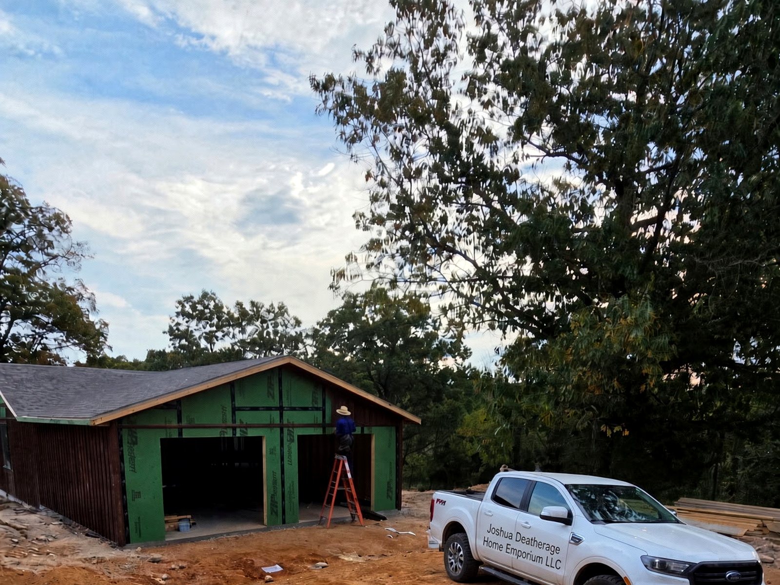 Crew truck and front of the house, sheathing underway