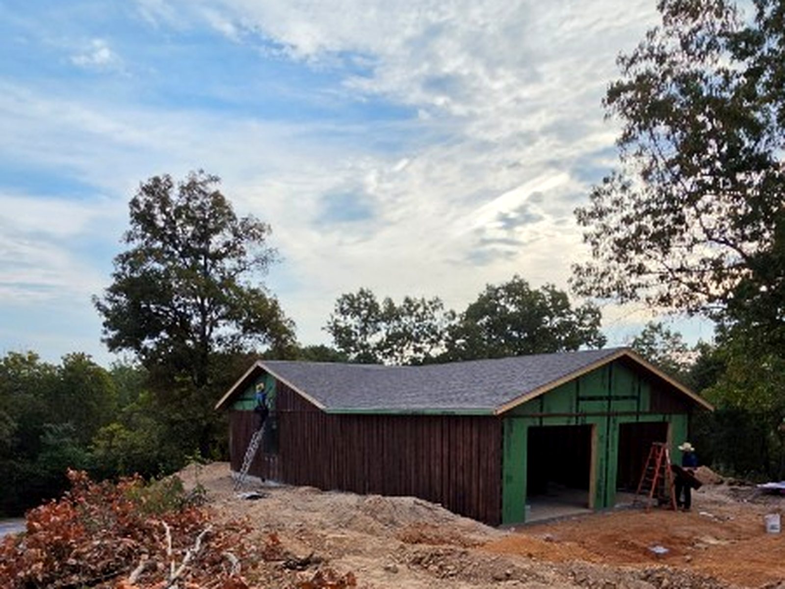 Side of the house with wood siding and the garage opening