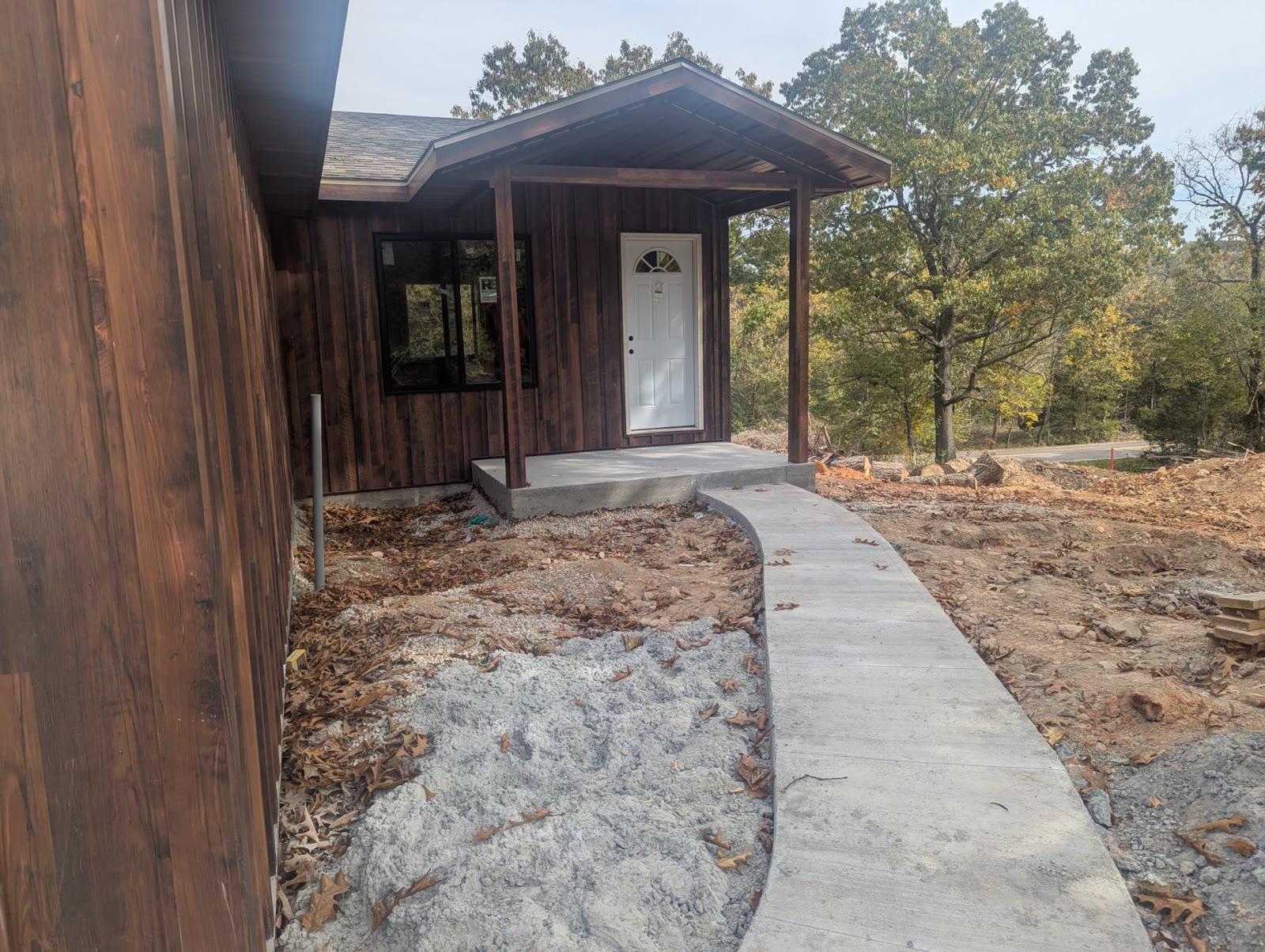 Front porch with a concrete walk and the white door set