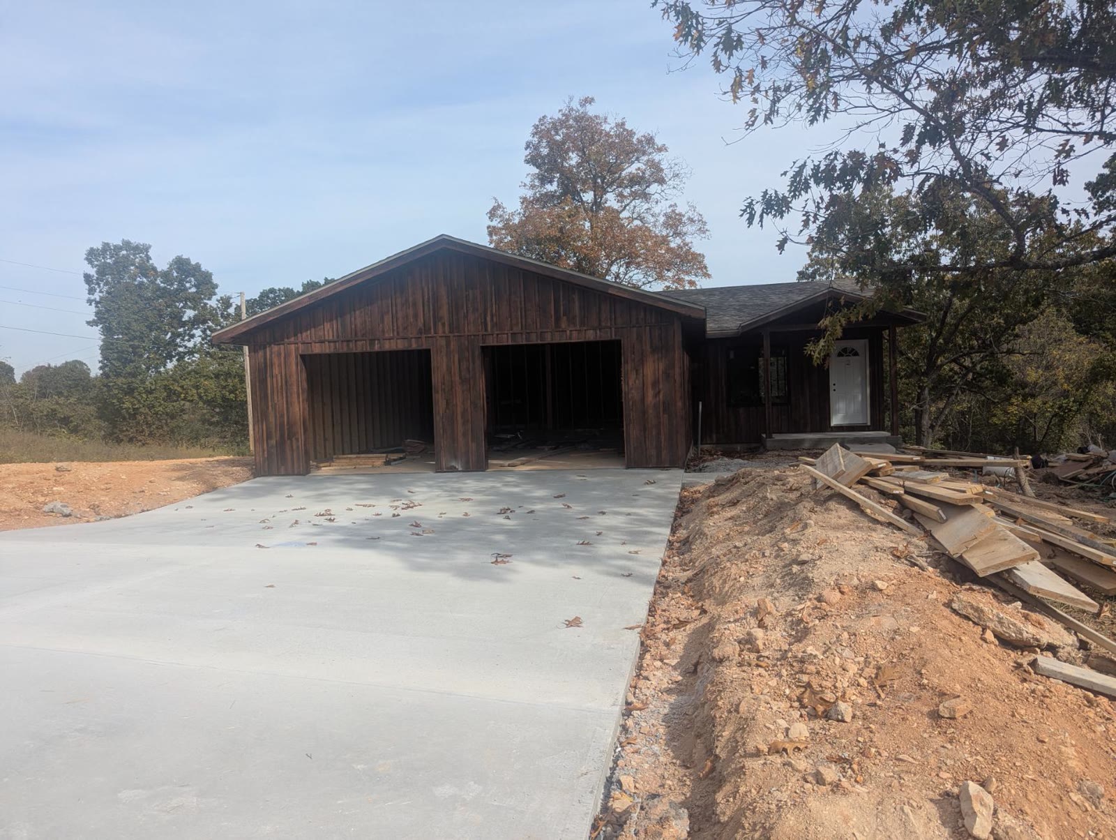 Concrete driveway in front of the open garage bays