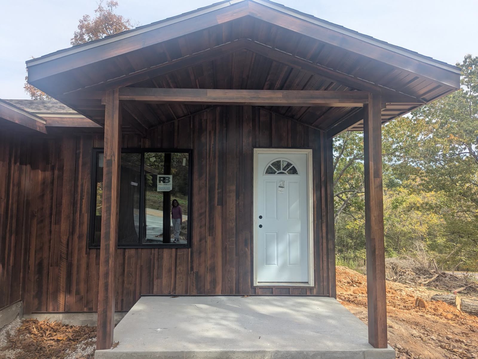Covered front porch, white door, and window